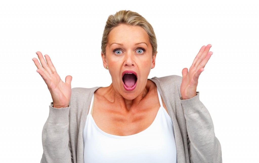 Surprised woman isolated against white background