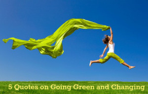 Beautiful young woman jumping on a green meadow with a colored tissue